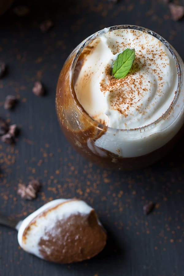 Top down shot of creamy chocolate avocado pudding in a glass. 