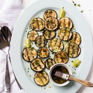 Overhead view of lemon garlic grilled zucchini on platter