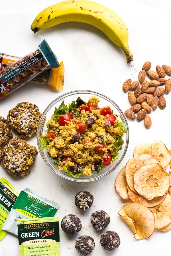 Top down shot of travel snacks on a white table. 