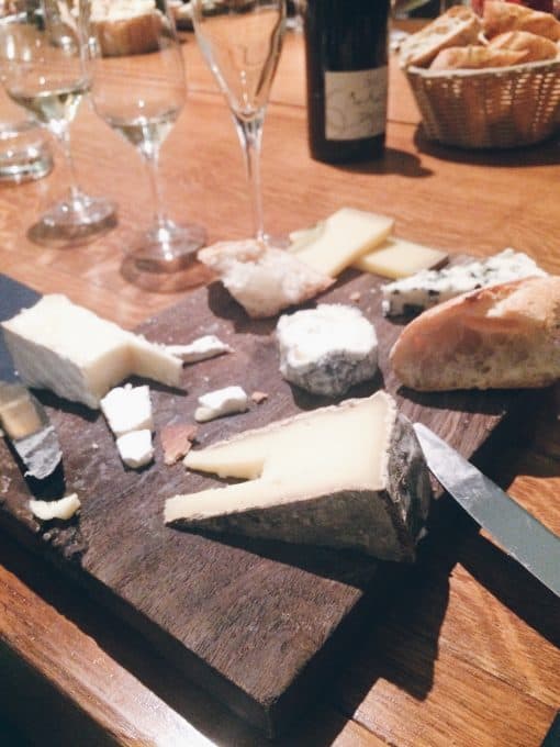 A cheese board on a restaurant table. 