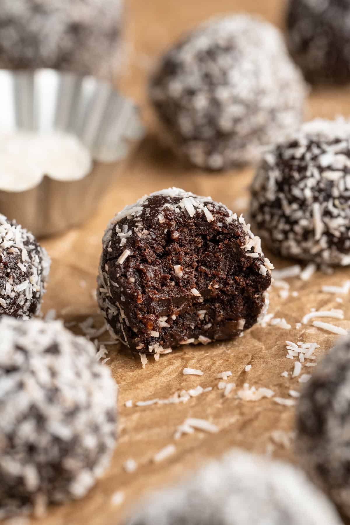 No bake brownie energy bite with bite taken out to show fudgy texture.