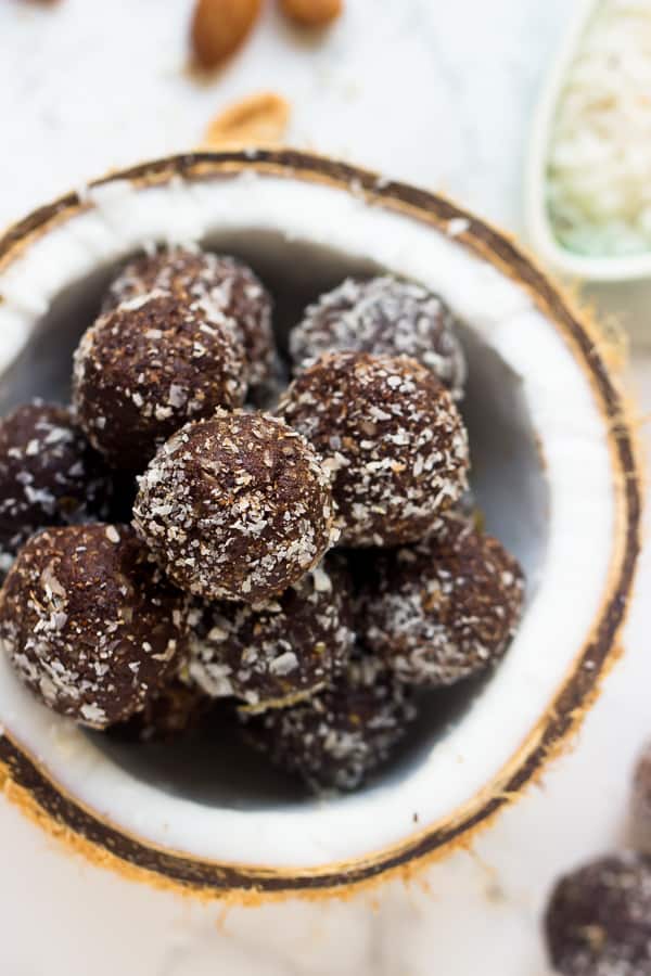 Overhead view of brownie energy bites in half a coconut. 