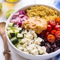 Mediterranean salad in a white bowl on a table.