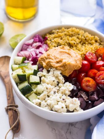 Mediterranean salad in a white bowl on a table.
