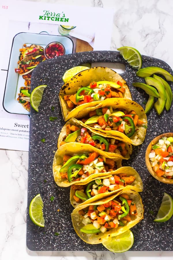 Overhead shot of sweet potato tacos on a chopping board.