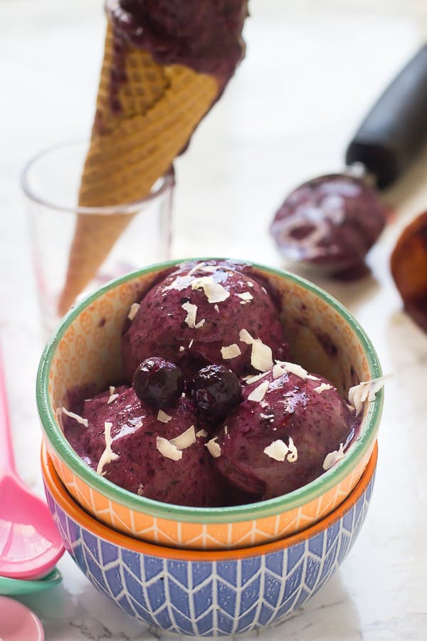 Three scoops of blueberry ice cream in a bowl. 