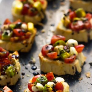 Side on shot of bruschetta on a grey slate.