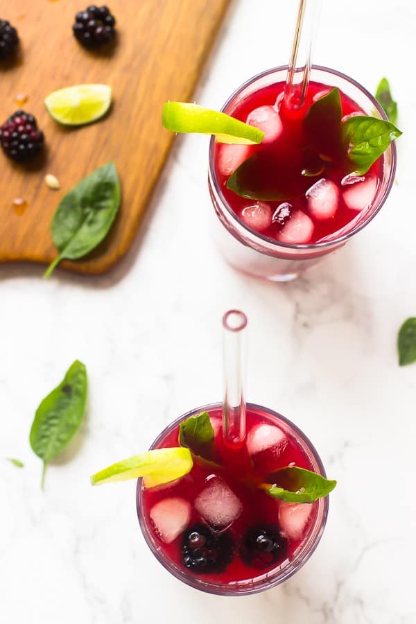 Top down shot of blackberry limeade in two glasses. 