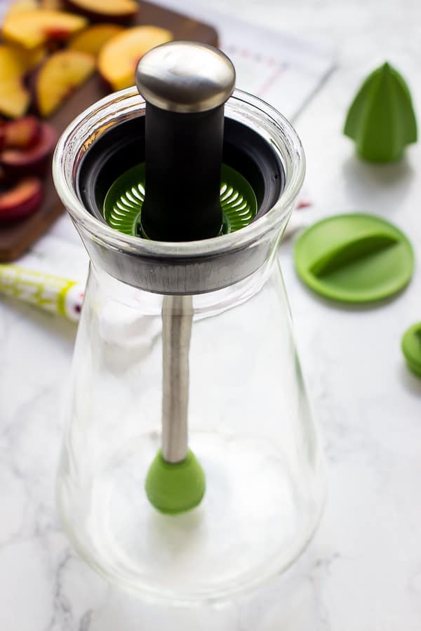 Side shot of glass infuser on a table.  