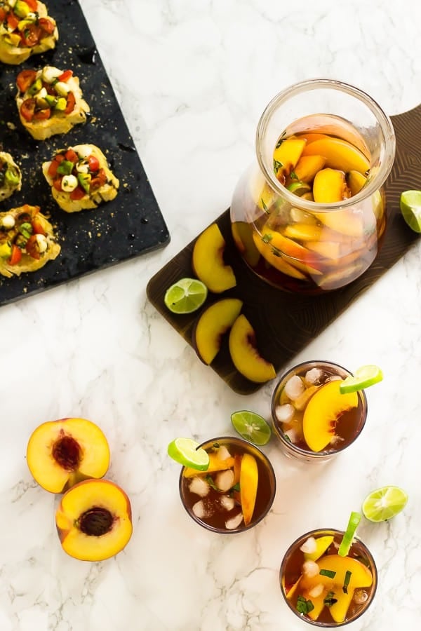 Overhead view of peach sangria in 3 glasses and pitcher