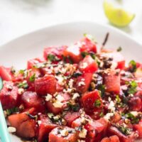 Watermelon feta salad on a white plate with balsamic drizzle.