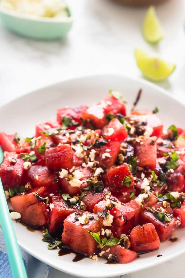 Watermelon feta salad on a white plate with balsamic drizzle.