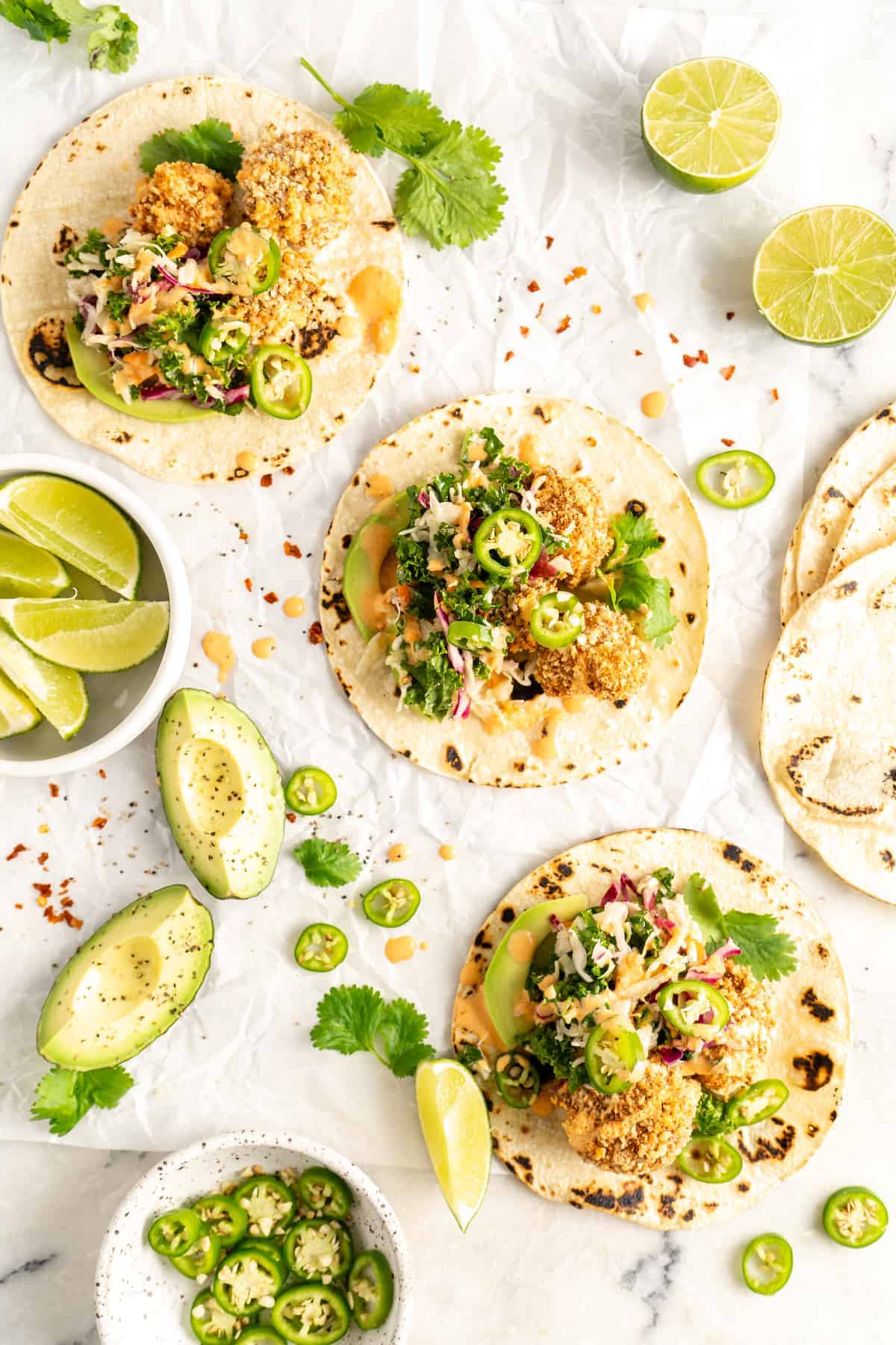 Overhead view of Crispy Cauliflower Tacos surrounded by garnishes