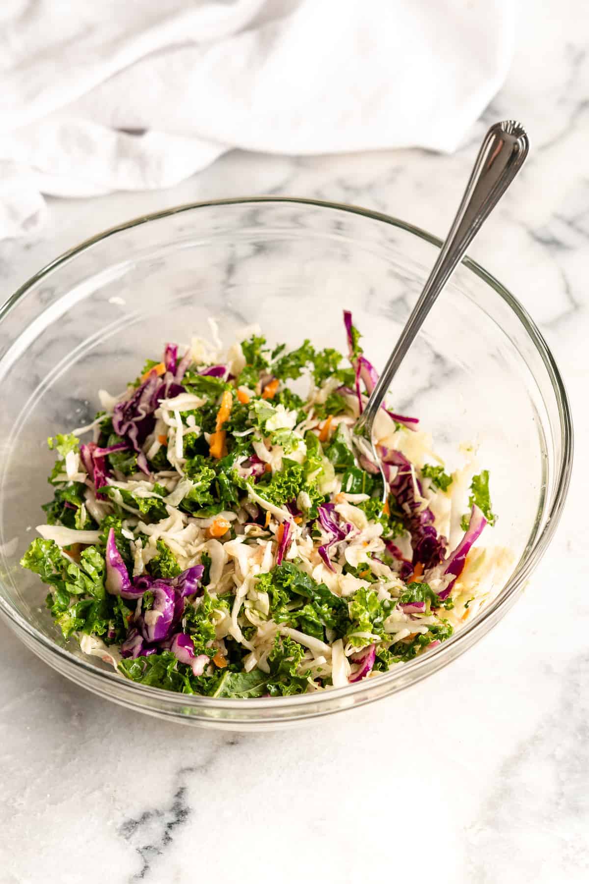 Slaw in glass bowl with spoon
