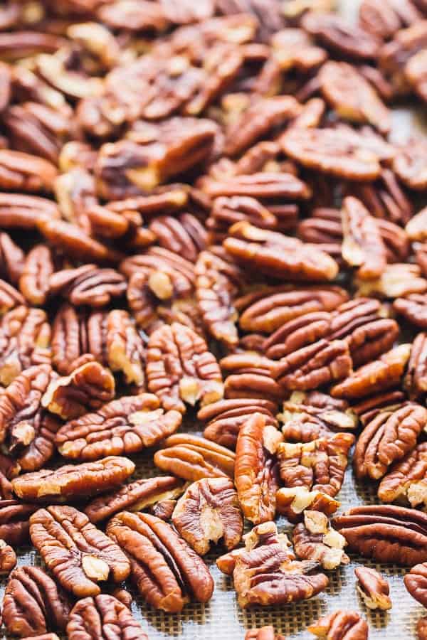 Close up of pecans on a baking tray.