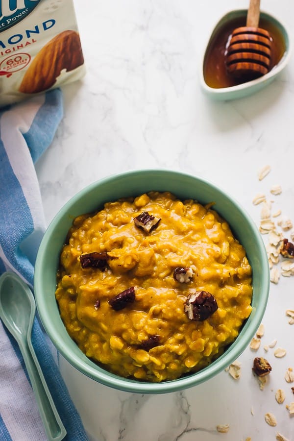 Overhead view of overnight pumpkin oats in a green bowl. 