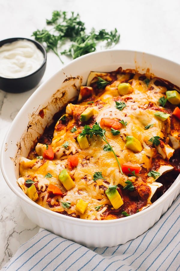 A baking dish of black bean enchiladas. 