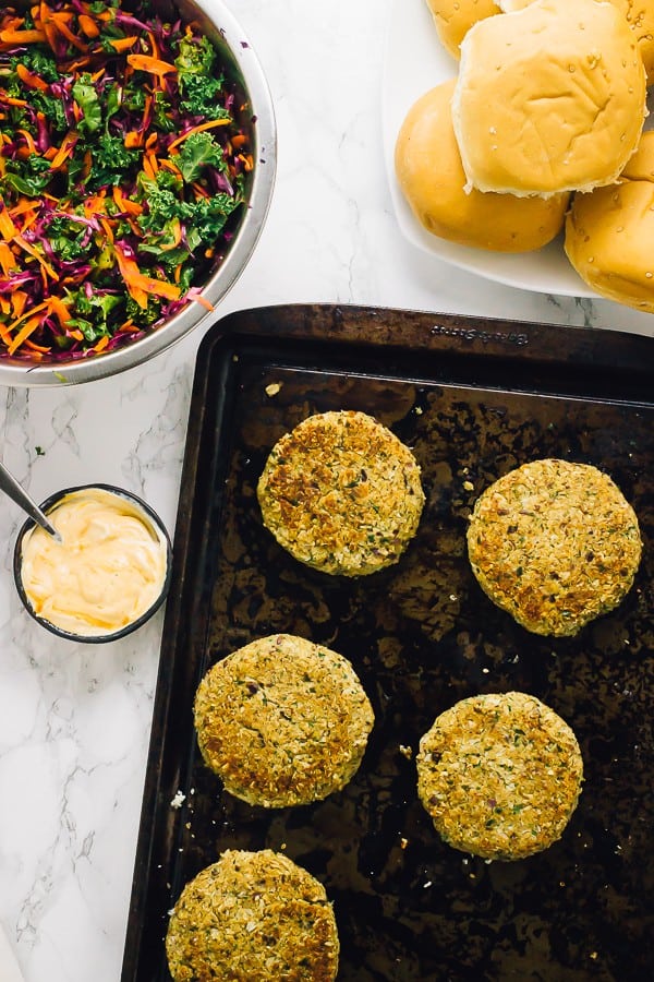 Top down shot of vegan quinoa cauliflower burger patties on a baking tray.