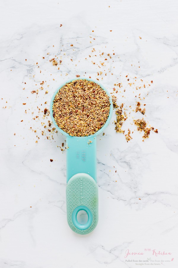 Overhead shot of flax seeds in a blue spoon.