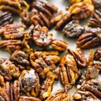 Top down shot of candied pecans on a baking tray.