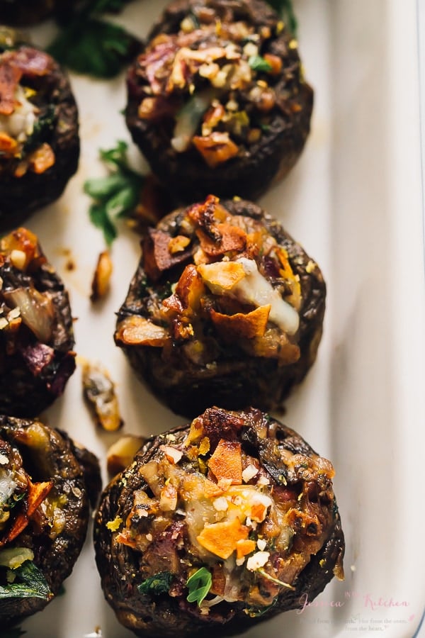 Overhead view of stuffed mushrooms in a white baking dish. 