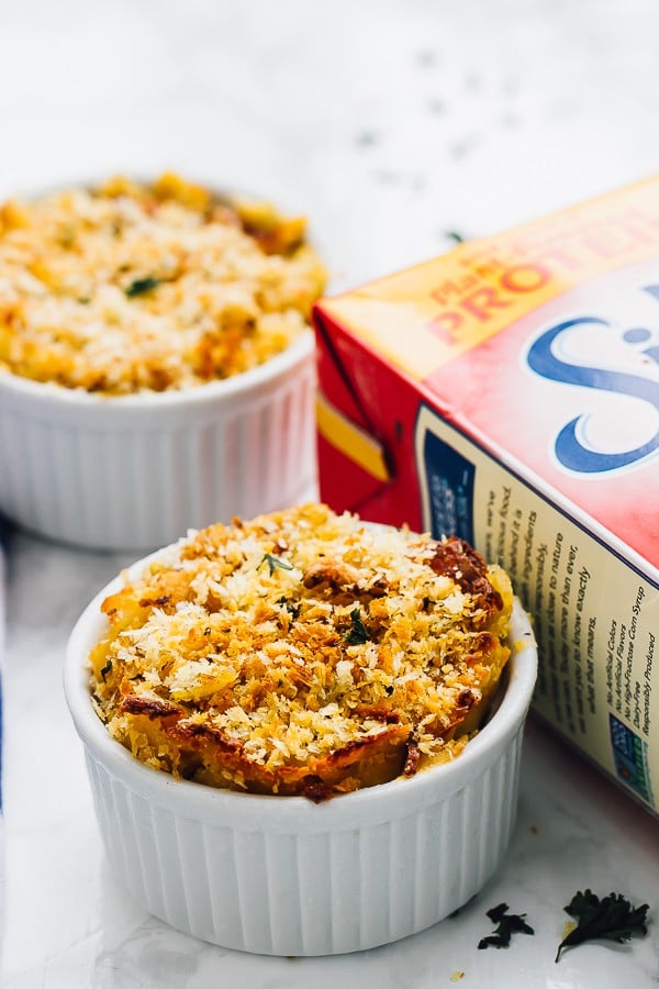 Side shot of vegan baked pumpkin mac and cheese in two white ramekins. 