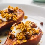 Side on shot of cinnamon baked pears with a crunchy topping.