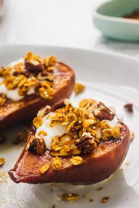 Side on shot of cinnamon baked pears with a crunchy topping.