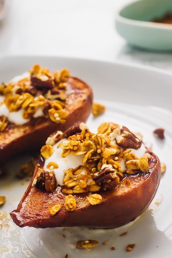  Two cinnamon baked pears on a white plate. 