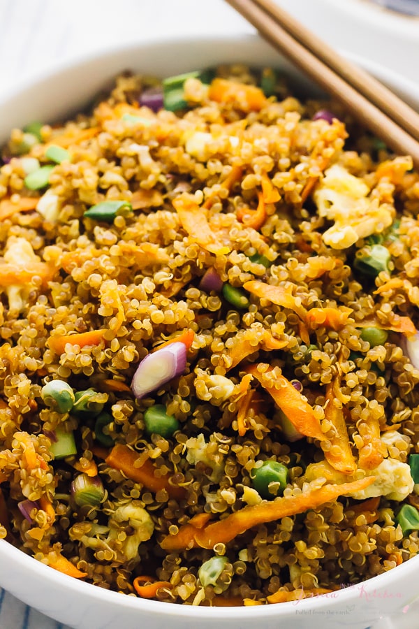 Close up of quinoa fried rice in a white bowl. 