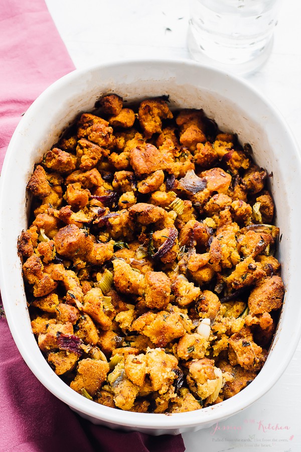 Top down shot of gluten free cornbread stuffing in a white baking dish.