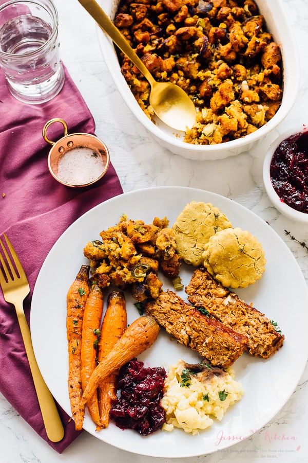 Gluten free cornbread stuffing on a plate with carrots and meatloaf. 