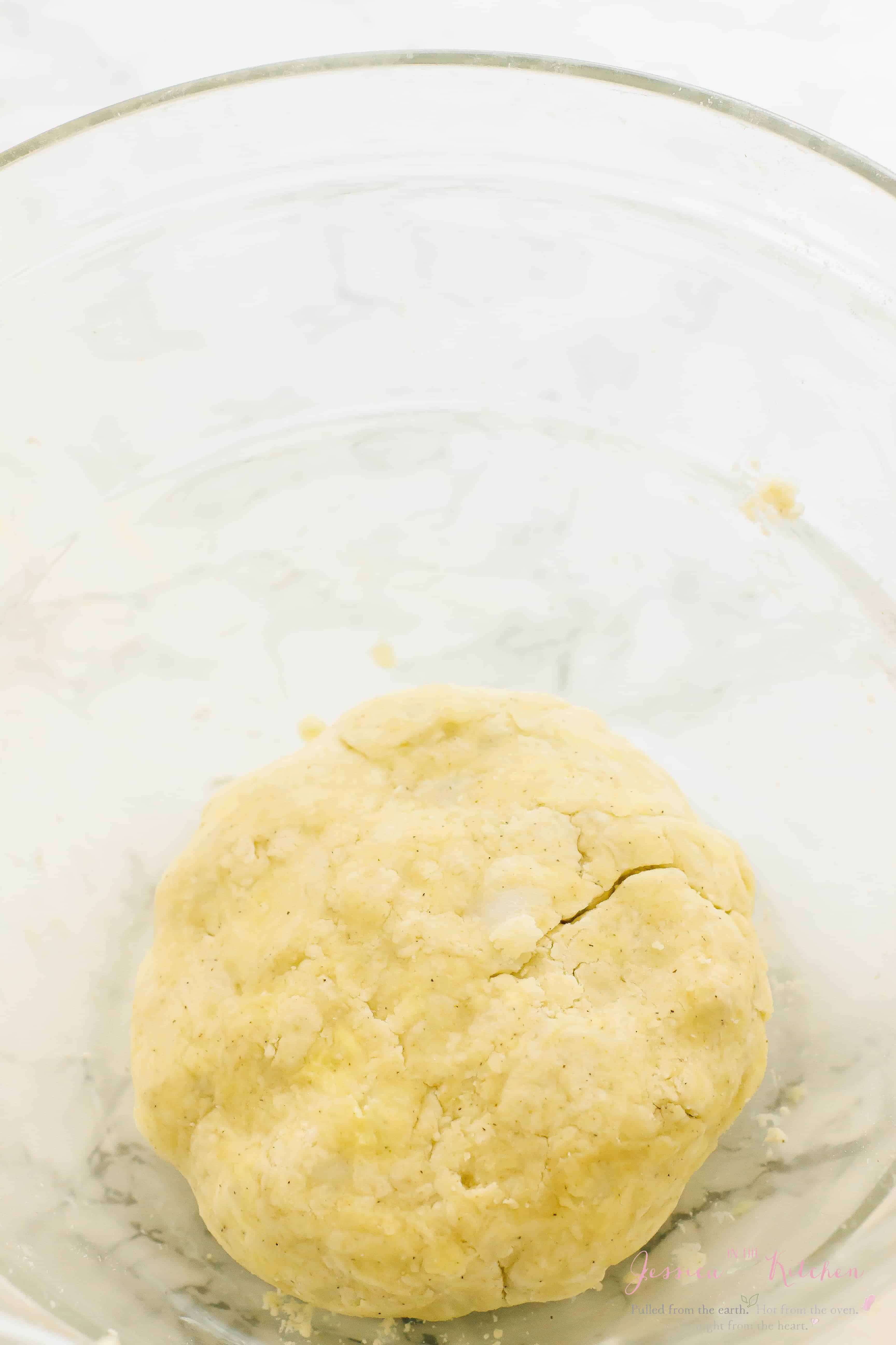 Gluten-free vegan pie crust dough in glass mixing bowl