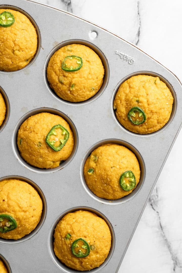 These moist vegan jalapeño cornbread muffins are easy to make and have a gluten-free option, which means everyone can enjoy them! Jalapeno cornbread muffins in pan.