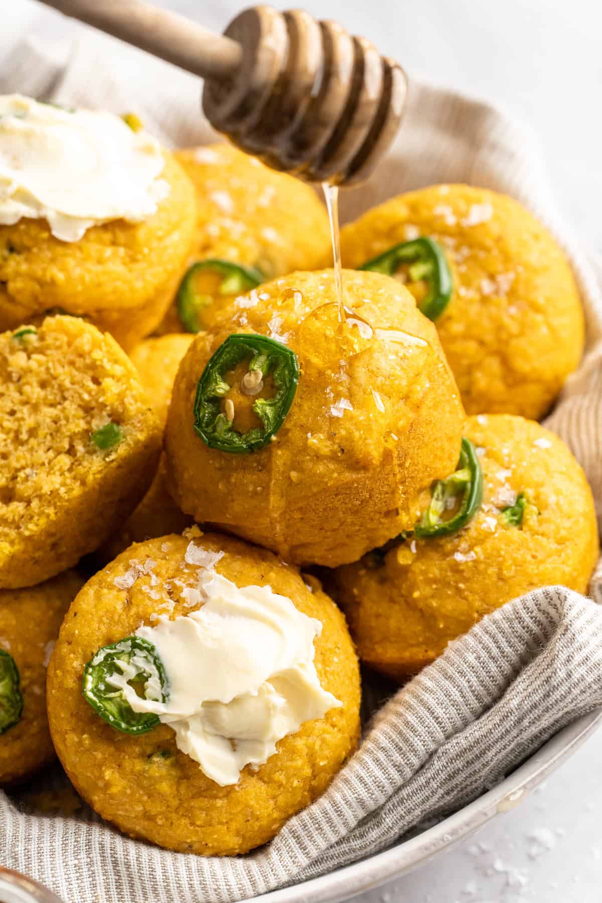 These moist vegan jalapeño cornbread muffins are easy to make and have a gluten-free option, which means everyone can enjoy them! Drizzling vegan honey over cornbread muffins.