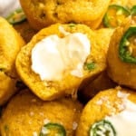Vegan cornbread muffins topped with butter and flaky salt.
