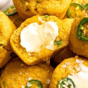 Vegan cornbread muffins topped with butter and flaky salt.