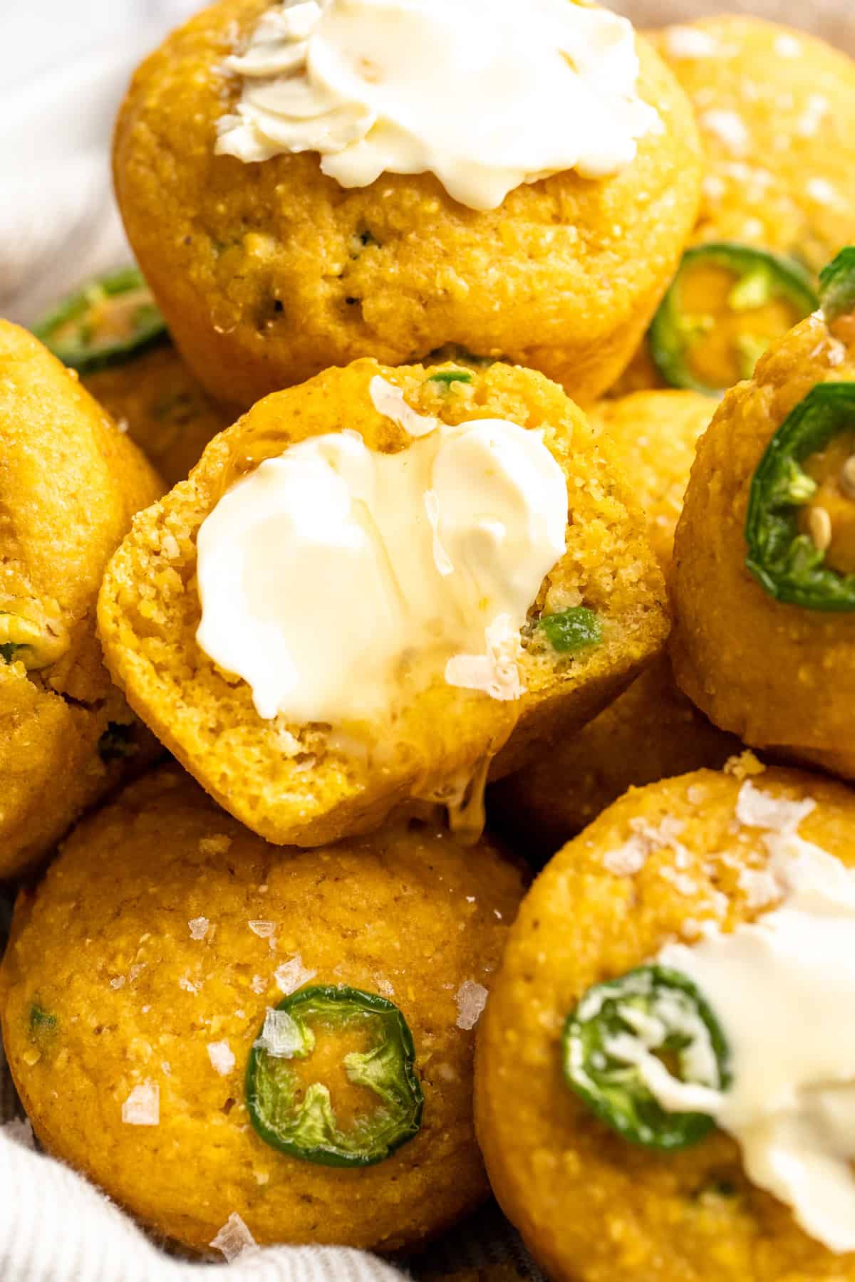 These moist vegan jalapeño cornbread muffins are easy to make and have a gluten-free option, which means everyone can enjoy them! Vegan cornbread muffins topped with butter and flaky salt.