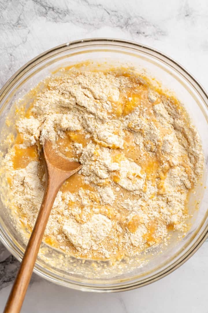 These moist vegan jalapeño cornbread muffins are easy to make and have a gluten-free option, which means everyone can enjoy them! Mixing dry and wet ingredients for cornbread in mixing bowl.