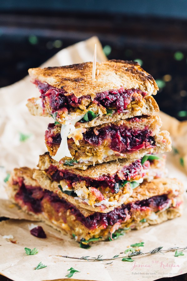 A stack of vegetarian meatloaf and cranberry thanksgiving leftover sandwich slices.