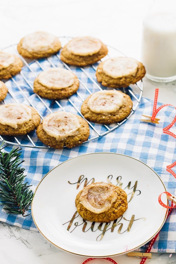 Pumpkin sugar cookies on a wire rack and a plate. 