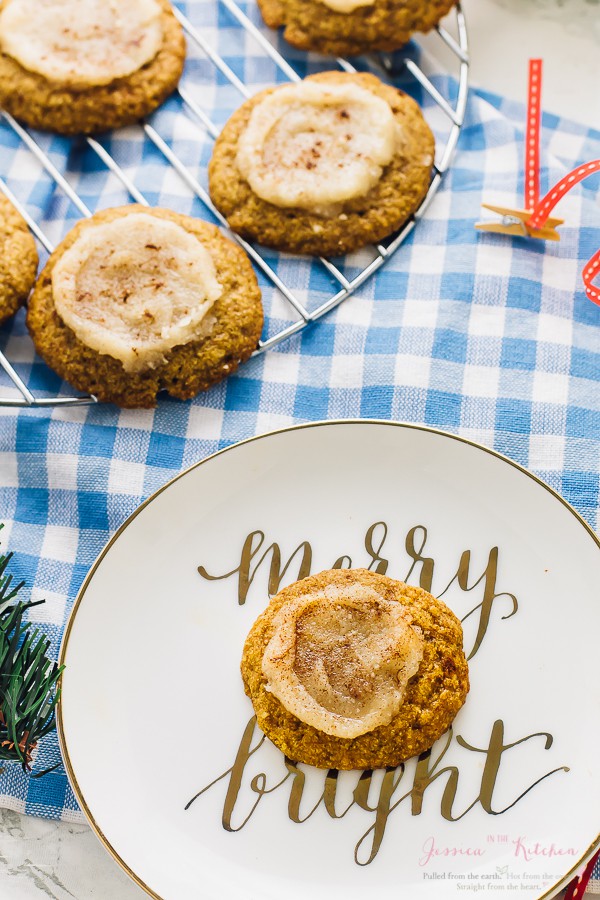 These Pumpkin Sugar Cookies are soft batch baked! They are an easy healthier festive cookie, vegan and gluten free, and are topped with an irresistible coconut butter frosting! via https://jessicainthekitchen.com