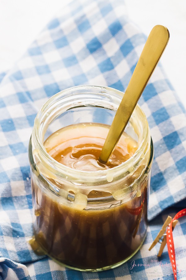 Cuillère en or dans le pot de sauce caramel végétalienne.