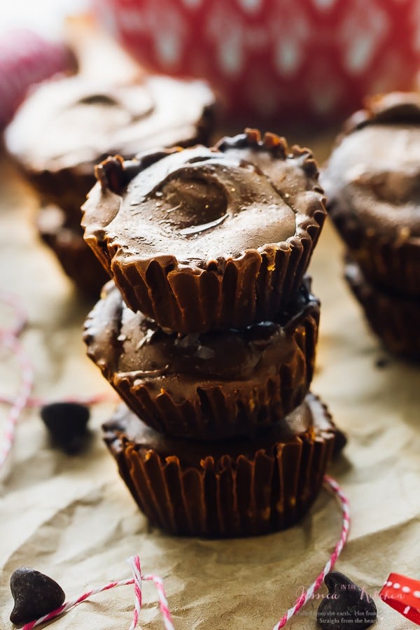 A stack of three vegan peanut butter cups on parchment paper. 
