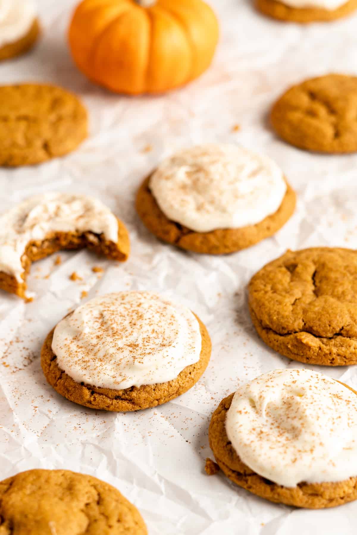 Frosted pumpkin sugar cookies with pumpkin spice.