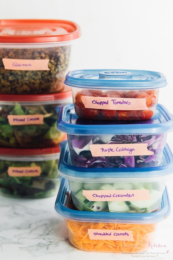 Ingredients in stacks of labelled tupperware containers. 