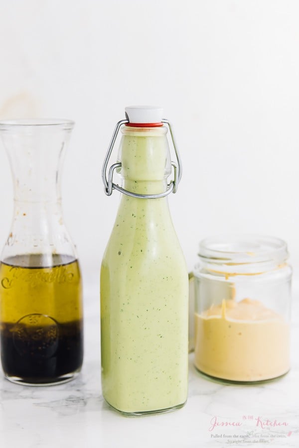 Side shot of salad dressing in various glass jars.