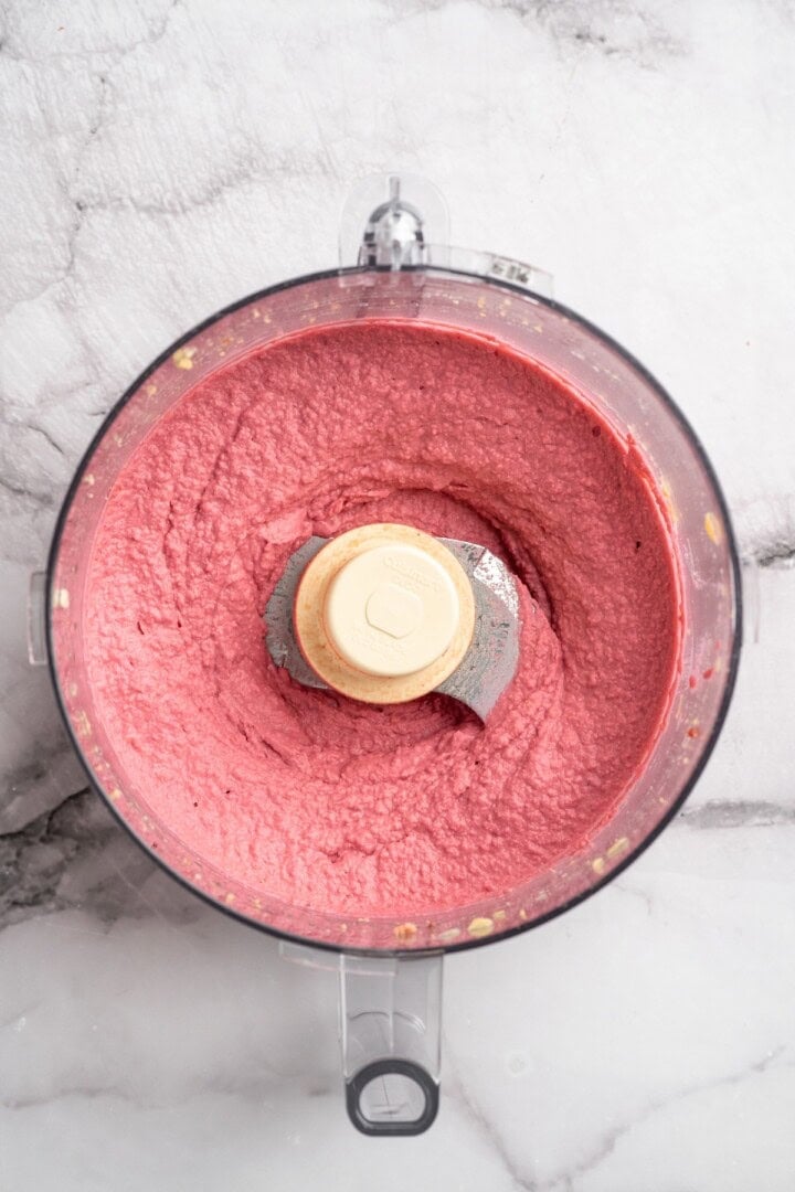Overhead view of beet hummus in food processor