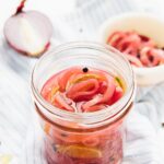 Pickled onions in a glass jar.