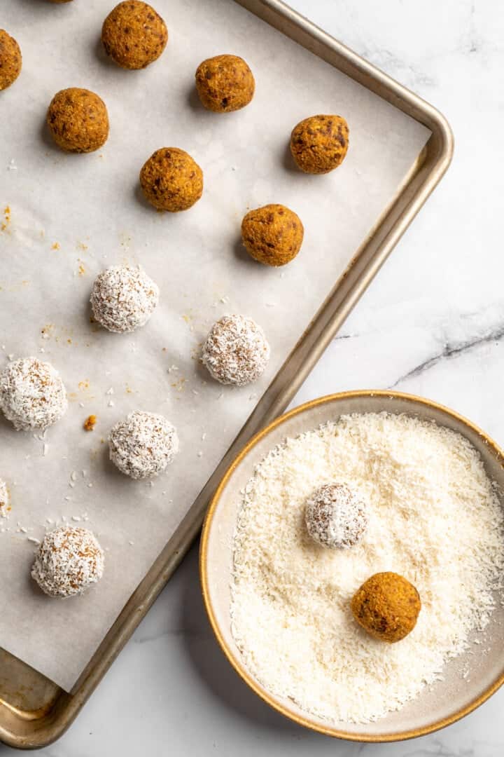 These no bake carrot cake energy bites are cozy, warmly spiced, and wholesome since they're made with nuts, carrots and dates for sweetness! No bake energy bites rolling in coconut flakes.